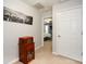 Hallway with a decorative cabinet, carpet flooring, and view into the bedroom at 125 N River Dr # F, Atlanta, GA 30350