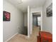 Hallway with neutral carpet leading to bedroom with artwork on the walls at 125 N River Dr # F, Atlanta, GA 30350