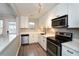 Stylish kitchen featuring stainless steel appliances, modern fixtures, and bright white cabinets at 125 N River Dr # F, Atlanta, GA 30350