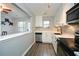 Bright kitchen boasts stainless appliances, white cabinets, and a view of the patio doors at 125 N River Dr # F, Atlanta, GA 30350