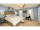 Spacious main bedroom with ample natural light, neutral carpet, and a ceiling fan at 125 N River Dr # F, Atlanta, GA 30350