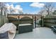 Private outdoor patio with a gate to the parking area; features a storage container and weather cover at 125 N River Dr # F, Atlanta, GA 30350