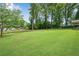 Large, lush backyard with mature trees, perfect for outdoor activities and enjoying nature at 4770 Wayland Cir, Acworth, GA 30101