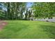 Expansive backyard featuring a well-maintained lawn and mature trees providing ample shade and privacy at 4770 Wayland Cir, Acworth, GA 30101