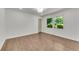 Bright bedroom featuring hardwood floors, a window offering outdoor views and modern recessed lighting at 4770 Wayland Cir, Acworth, GA 30101