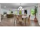 Dining room featuring hardwood floors and neutral color scheme open to living area at 4770 Wayland Cir, Acworth, GA 30101