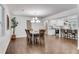 Open-concept dining room with hardwood floors, elegant lighting, and easy access to modern kitchen at 4770 Wayland Cir, Acworth, GA 30101