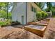 Beautifully landscaped side yard with terraced garden beds and a classic painted brick exterior at 4770 Wayland Cir, Acworth, GA 30101