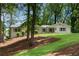 Beautifully landscaped front yard with mature trees and a well-maintained lawn, enhancing curb appeal at 4770 Wayland Cir, Acworth, GA 30101