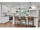 Bright kitchen with white cabinets, granite countertops, island with seating, and stainless steel appliances at 4770 Wayland Cir, Acworth, GA 30101