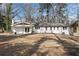 Rear exterior view of the home, showing a fire pit, freshly painted white siding, and a well-maintained yard at 4770 Wayland Cir, Acworth, GA 30101