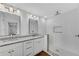 Modern bathroom with granite dual vanities, large mirror, and tiled walk-in shower at 4770 Wayland Cir, Acworth, GA 30101