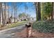 Exterior view of house with updated mailbox, long driveway, and surrounded by mature trees at 4770 Wayland Cir, Acworth, GA 30101