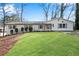Charming home featuring a well-manicured lawn, neutral paint, and complemented by lush greenery and mature trees at 4770 Wayland Cir, Acworth, GA 30101