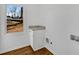 Bright laundry room with granite countertop, cabinet, and view from window at 4770 Wayland Cir, Acworth, GA 30101
