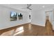Bright living room featuring hardwood floors, a ceiling fan, and natural light from the windows at 4770 Wayland Cir, Acworth, GA 30101