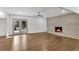 Living room featuring wood floors, fresh paint, and brick fireplace at 4770 Wayland Cir, Acworth, GA 30101