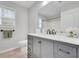 Well-lit bathroom with gray cabinets, marble countertops, and modern fixtures at 10 Oakbrook Ln, Covington, GA 30016