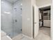 Modern bathroom with glass shower, tile walls, and walk-in closet access at 11 Ganel Ln, Alpharetta, GA 30009