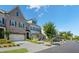 Beautiful townhome exterior featuring a brick facade, a well-manicured lawn, and a tree-lined street at 11 Ganel Ln, Alpharetta, GA 30009