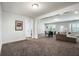 Large and open living room and dining room featuring plush carpet, a large seating area, and natural light at 11 Ganel Ln, Alpharetta, GA 30009