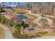 A serene community pond is seen from the entrance and brick Harlow West sign at 11 Ganel Ln, Alpharetta, GA 30009