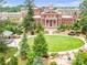 An aerial view of a town green space with mature trees, a fountain, and a historic building at 11 Ganel Ln, Alpharetta, GA 30009