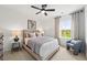 Bright bedroom with large window, a ceiling fan, and neutral-colored decor at 1639 Tide Mill Rd, Cumming, GA 30040