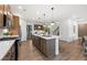 Modern kitchen island with white countertop, sink, and seating with adjacent dining area at 1639 Tide Mill Rd, Cumming, GA 30040