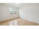 Bright, minimalist bedroom with hardwood floors and large windows at 176 Rhodesia Se Ave, Atlanta, GA 30315