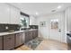 Modern kitchen with stylish gray and white cabinets, a stainless steel dishwasher, and open door at 176 Rhodesia Se Ave, Atlanta, GA 30315