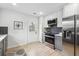 Bright kitchen features stainless steel appliances, gray cabinets, white countertops, and herringbone backsplash at 176 Rhodesia Se Ave, Atlanta, GA 30315