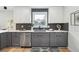 Charming kitchen featuring gray cabinets, white countertops, stainless steel appliances, and herringbone backsplash at 176 Rhodesia Se Ave, Atlanta, GA 30315