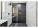 Contemporary shower with mosaic tile floor and modern fixtures and shelving at 176 Rhodesia Se Ave, Atlanta, GA 30315