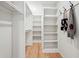 Bright walk-in closet with custom shelving, ample storage space, and wood flooring at 176 Rhodesia Se Ave, Atlanta, GA 30315