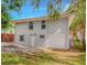 Rear exterior view of home featuring private entrance, single-car garage, and level backyard at 1857 Dunlap Ave, East Point, GA 30344