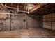 Unfinished basement space features cement floors and exposed ceiling at 1857 Dunlap Ave, East Point, GA 30344