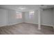 Finished basement featuring modern gray walls, wood flooring, and natural light streaming through windows at 1857 Dunlap Ave, East Point, GA 30344