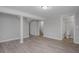 Finished basement featuring modern gray walls, wood flooring, and entry to bathroom at 1857 Dunlap Ave, East Point, GA 30344