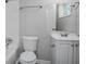 Bright bathroom showcasing a toilet, vanity, mirror, and bathtub with shower setup at 1857 Dunlap Ave, East Point, GA 30344