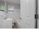 Neat bathroom with white tile walls, a white vanity, and updated fixtures at 1857 Dunlap Ave, East Point, GA 30344