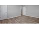 Bedroom features gray walls, new wood floors, and white baseboards at 1857 Dunlap Ave, East Point, GA 30344