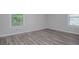 Bedroom features gray walls, new wood floors, and white baseboards at 1857 Dunlap Ave, East Point, GA 30344