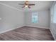 Bright bedroom features modern ceiling fan, new floors and natural light at 1857 Dunlap Ave, East Point, GA 30344