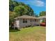 Exterior featuring a lawn, small porch and a blue sky with trees at 1857 Dunlap Ave, East Point, GA 30344