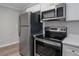 Modern kitchen featuring stainless steel appliances and clean white cabinetry at 1857 Dunlap Ave, East Point, GA 30344