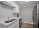 Modern kitchen featuring stainless steel appliances, white cabinetry, and a double sink at 1857 Dunlap Ave, East Point, GA 30344