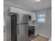 Updated kitchen featuring stainless steel appliances, white cabinetry, and hardwood flooring at 1857 Dunlap Ave, East Point, GA 30344