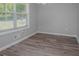 Bright living room featuring modern gray walls and light brown hardwood floors at 1857 Dunlap Ave, East Point, GA 30344