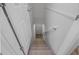 Carpeted stairs descend, framed by white walls and banisters, with a glimpse of lower-level flooring at 1857 Dunlap Ave, East Point, GA 30344